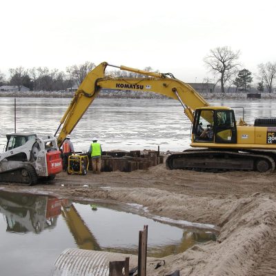 Heavy Machinery Removing Physical Obstructions from a River Channel